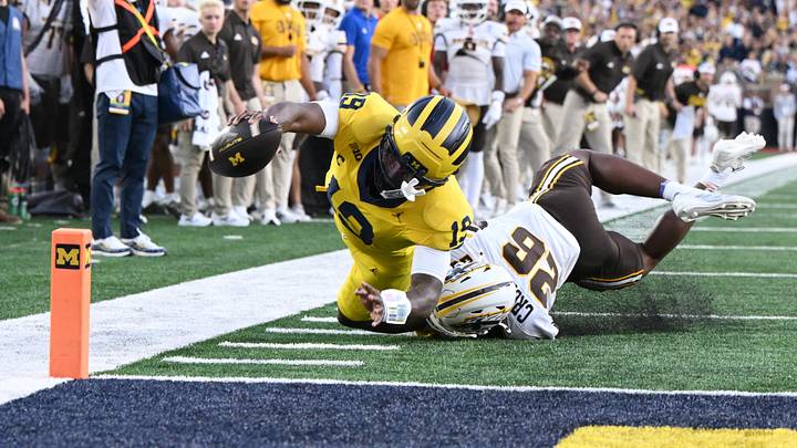 Michigan quarterback Bryce Underwood stretches the ball toward the pylon but comes up short of a touchdown while being tackled by Western Michigan safety Trevon Collard in the first quarter Michigan quarterback Bryce Underwood stretches the ball toward the pylon but comes up short of a touchdown while being tackled by Western Michigan safety Trevon Collard in the first quarter