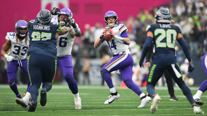 Dec 22, 2024; Seattle, Washington, USA; Minnesota Vikings quarterback Sam Darnold (14) looks to pass the ball during the first half against the Seattle Seahawks at Lumen Field. 