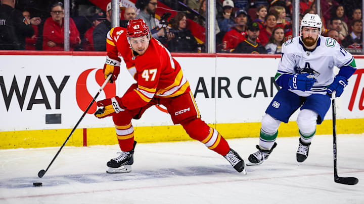 Mar 12, 2025; Calgary, Alberta, CAN; Calgary Flames center Connor Zary (47) controls the puck against Vancouver Canucks defenseman Filip Hronek (17) during the second period at Scotiabank Saddledome. Mandatory Credit: Sergei Belski-Imagn Images Mar 12, 2025; Calgary, Alberta, CAN; Calgary Flames center Connor Zary (47) controls the puck against Vancouver Canucks defenseman Filip Hronek (17) during the second period at Scotiabank Saddledome. Mandatory Credit: Sergei Belski-Imagn Images
