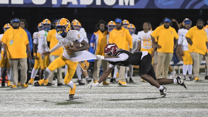 Miami Northwestern's Calvin Russell Jr. breaks a tackle during the Class 3A state championship on Dec. 14, 2024.