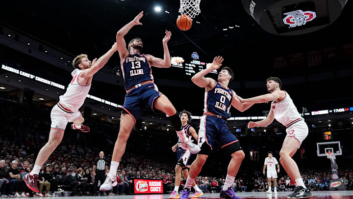 Ohio State Buckeyes forward Brandon Noel (14) fights for a rebound with Illinois Fighting Illini center Tomislav Ivisic (13) an dforward David Mirkovic (0) during the first half of the NCAA men's basketball game in Columbus on Dec. 9, 2025. Ohio State Buckeyes forward Brandon Noel (14) fights for a rebound with Illinois Fighting Illini center Tomislav Ivisic (13) an dforward David Mirkovic (0) during the first half of the NCAA men's basketball game in Columbus on Dec. 9, 2025.