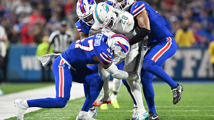Sep 18, 2025; Orchard Park, New York, USA; Buffalo Bills linebacker Terrel Bernard (8) and cornerback Christian Benford (47) tackle Miami Dolphins running back de'von Achane (28)