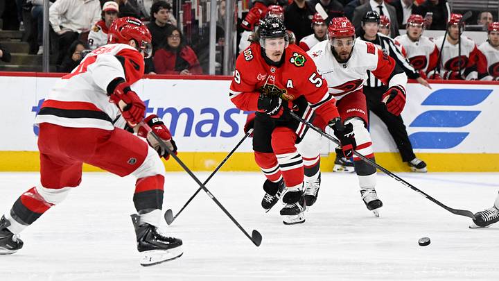 Apr 9, 2026; Chicago, Illinois, USA; Chicago Blackhawks left wing Tyler Bertuzzi (59) moves the puck against Carolina Hurricanes defenseman Shayne Gostisbehere (4) during the first period at the United Center. Mandatory Credit: Matt Marton-Imagn Images