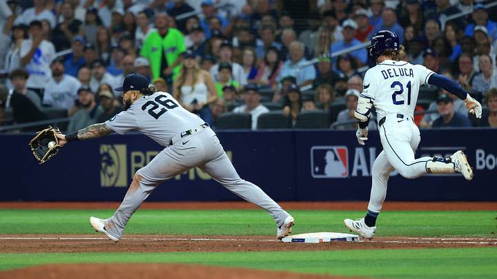 Oct 5, 2026; St. Petersburg, Florida, USA; Tampa Bay Rays outfielder Jonny DeLuca (21) reaches on an error during the fifth inning against the New York Yankees in game two of the ALDS for the 2026 MLB Playoffs at Tropicana Field. Mandatory Credit: Kim Klement Neitzel-Imagn Images Oct 5, 2026; St. Petersburg, Florida, USA; Tampa Bay Rays outfielder Jonny DeLuca (21) reaches on an error during the fifth inning against the New York Yankees in game two of the ALDS for the 2026 MLB Playoffs at Tropicana Field. Mandatory Credit: Kim Klement Neitzel-Imagn Images