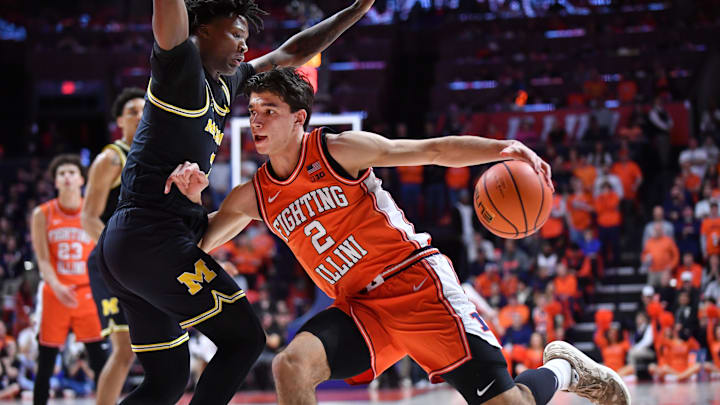 Feb 27, 2026; Champaign, Illinois, USA;  Illinois Fighting Illini guard Andrej Stojakovic (2) drives the ball against Michigan Wolverines guard L.J. Cason (2) during the first half at State Farm Center. Mandatory Credit: Ron Johnson-Imagn Images