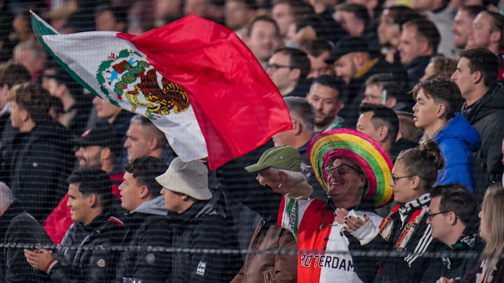 A fan waves a Mexican flag