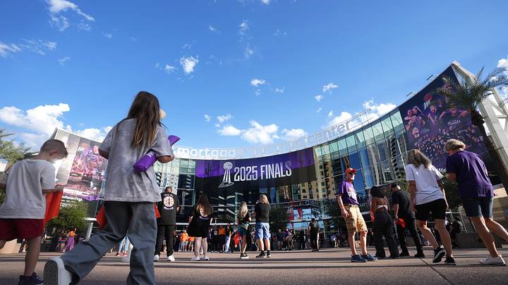 Fans walk into the Mortgage Matchup Center for WNBA Finals Game 3 between the Phoenix Mercury and Las Vegas Aces in Phoenix on Oct. 8, 2025.