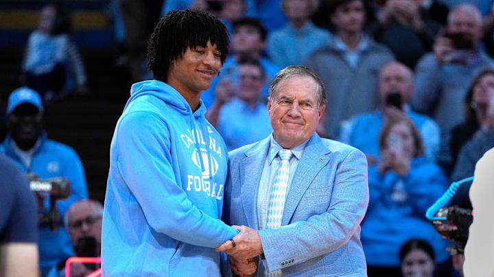 Dec 14, 2024; Chapel Hill, North Carolina, USA; North Carolina Tar Heels head football coach Bill Belichick with recruit quarterback Bryce Baker during half time at Dean E. Smith Center. Mandatory Credit: Bob Donnan-Imagn Images Dec 14, 2024; Chapel Hill, North Carolina, USA; North Carolina Tar Heels head football coach Bill Belichick with recruit quarterback Bryce Baker during half time at Dean E. Smith Center. Mandatory Credit: Bob Donnan-Imagn Images