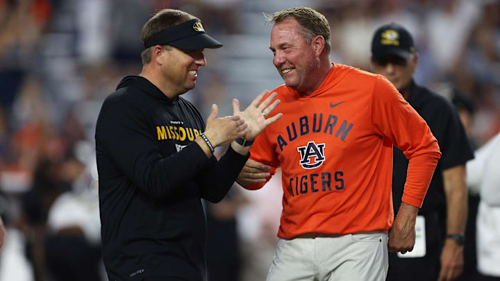 Oct 18, 2025; Auburn, Alabama, USA; Missouri Tigers head coach Eli Drinkwitz and Auburn Tigers head coach Hugh Freeze speak before the game at Jordan-Hare Stadium. Mandatory Credit: John Reed-Imagn Images