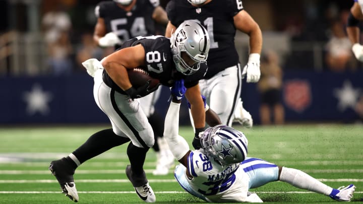 Aug 26, 2023; Arlington, Texas, USA; Las Vegas Raiders tight end Michael Mayer (87) is tackled by Dallas Cowboys cornerback D'Angelo Mandell (38) in the second quarter at AT&T Stadium. Mandatory Credit: Tim Heitman-USA TODAY Sports