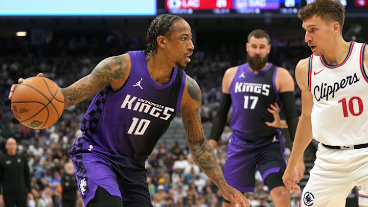 Apr 11, 2025; Sacramento, California, USA; Sacramento Kings forward DeMar DeRozan (left) dribbles against Los Angeles Clippers guard Bogdan Bogdanovic (right) during the first quarter at Golden 1 Center. Mandatory Credit: Darren Yamashita-Imagn Images Apr 11, 2025; Sacramento, California, USA; Sacramento Kings forward DeMar DeRozan (left) dribbles against Los Angeles Clippers guard Bogdan Bogdanovic (right) during the first quarter at Golden 1 Center. Mandatory Credit: Darren Yamashita-Imagn Images