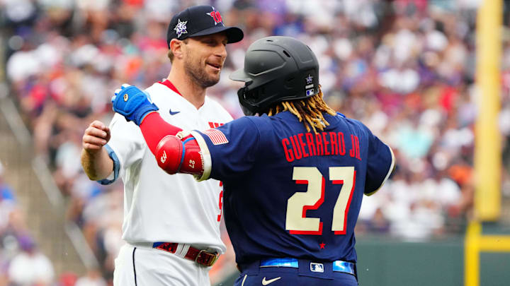 Jul 13, 2021: National League starting pitcher Max Scherzer of the Washington Nationals (31) hugs American League first baseman Vladimir Guerrero Jr. of the Toronto Blue Jays (27) during the first inning of the 2021 MLB All Star Game at Coors Field. 