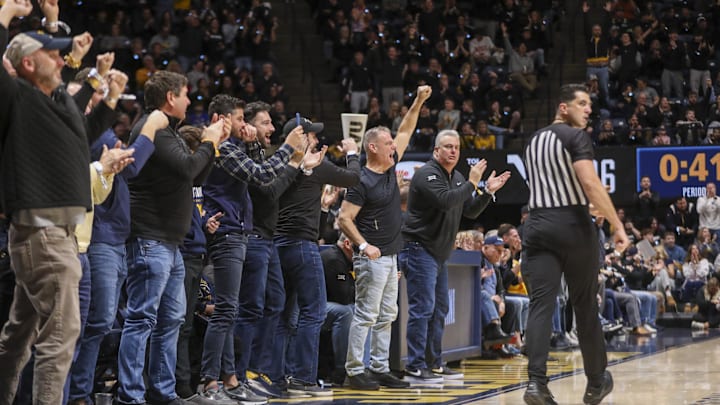 Feb 8, 2025; Morgantown, West Virginia, USA; West Virginia Mountaineers fans cheer during the first half against the Utah Utes at WVU Coliseum. Mandatory Credit: Ben Queen-Imagn Images Feb 8, 2025; Morgantown, West Virginia, USA; West Virginia Mountaineers fans cheer during the first half against the Utah Utes at WVU Coliseum. Mandatory Credit: Ben Queen-Imagn Images