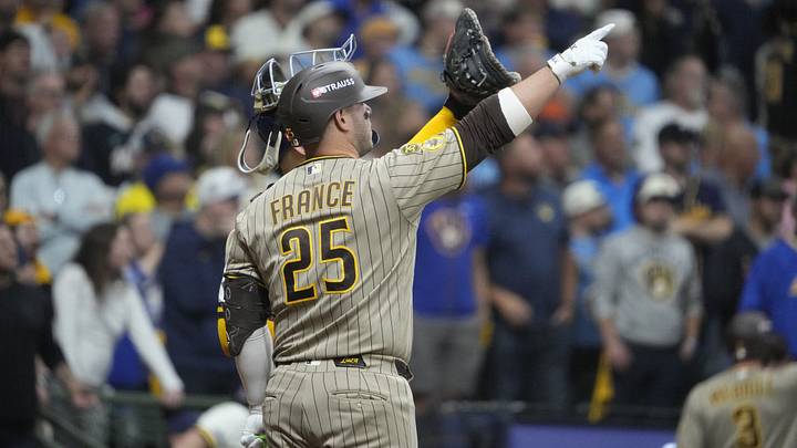 Oct 3, 2026; Milwaukee, Wisconsin, USA; San Diego Padres first baseman Ty France (25) discusses a play where the ball may have hit a wire on the top of the dome of the stadium during the ninth inning against the Milwaukee Brewers in game one of the NLDS for the 2026 MLB Playoffs at American Family Field. Mandatory Credit: Michael McLoone-Imagn Images Oct 3, 2026; Milwaukee, Wisconsin, USA; San Diego Padres first baseman Ty France (25) discusses a play where the ball may have hit a wire on the top of the dome of the stadium during the ninth inning against the Milwaukee Brewers in game one of the NLDS for the 2026 MLB Playoffs at American Family Field. Mandatory Credit: Michael McLoone-Imagn Images