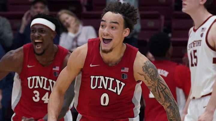 UNLV Runnin' Rebels guard Dra Gibbs-Lawhorn (0) and center Emmanuel Stephen (34) celebrate after the buzzer sounds as Stanford Cardinal forward/center Oskar Giltay (15) looks on in the second half at Maples Pavilion. Mandatory Credit: David Gonzales-Imagn Images