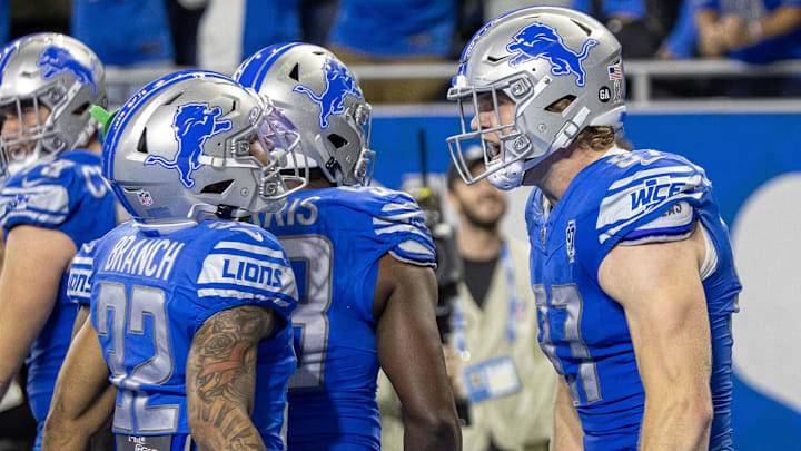Nov 19, 2023; Detroit, Michigan, USA; Detroit Lions defensive end Aidan Hutchinson (97) and safety Brian Branch (32) celebrate the two point touch back against the Chicago Bears late in the fourth quarter at Ford Field. Mandatory Credit: David Reginek-Imagn Images