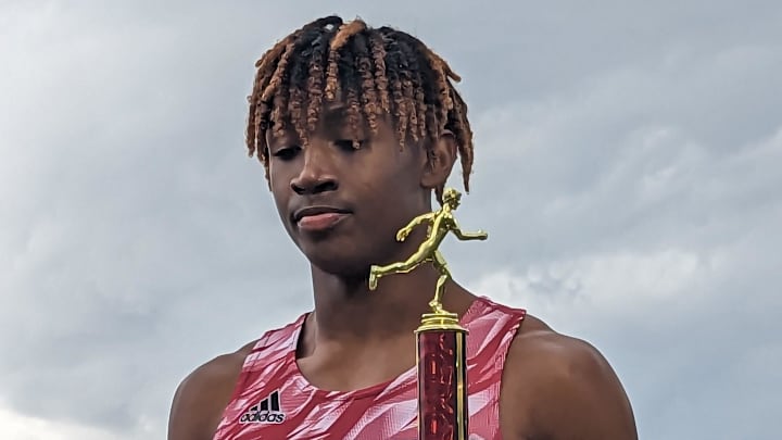 Florida High's Micahi Danzy holds the championship trophy from the boys 400-meter run at the Bob Hayes Invitational Trophy on March 18, 2023. [Clayton Freeman/Florida Times-Union]

Pxl 20230318 211918691