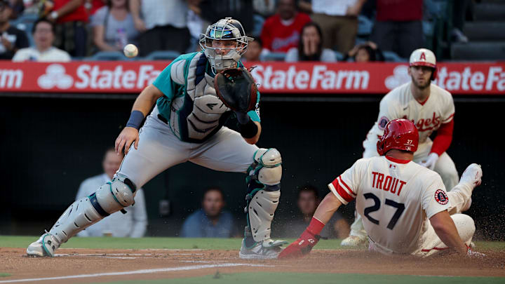 Angels center fielder Mike Trout (27) slides home to score against Seattle Mariners catcher Cal Raleigh (29) on Sept. 17, 2022.