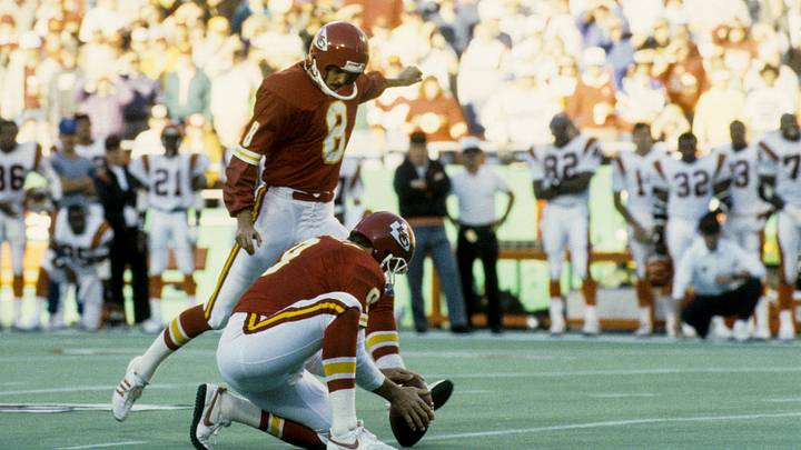 Nov 13, 1988; Kansas City, MO, USA; FILE PHOTO; Kansas City Chiefs quarterback Bill Kenny (9) holds the ball for kicker Nick Lowery (8) as he kicks the game winning field goal against the Cincinnati Bengals at Arrowhead Stadium. Mandatory Credit Herb Weitman-Imagn Images