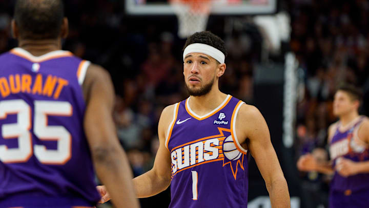 Apr 7, 2024; Phoenix, Arizona, USA;  Phoenix Suns guard Devin Booker (1) and forward Kevin Durant (35) react between plays against the New Orleans Pelicans in the second half at Footprint Center. Mandatory Credit: Allan Henry-Imagn Images