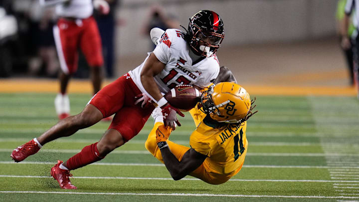 Oct 7, 2023; Waco, Texas, USA; Texas Tech Red Raiders defensive back Bralyn Lux (12) breaks up a pass intended for Baylor Bears wide receiver Ketron Jackson Jr. (11) during the first half at McLane Stadium. Mandatory Credit: Chris Jones-USA TODAY Sports