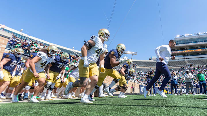Apr 12, 2025; Notre Dame, IN, USA; Notre Dame Fighting Irish head coach Marcus Freeman leads the team onto the field during the Blue-Gold game at Notre Dame Stadium. Mandatory Credit: Michael Caterina-Imagn Images Apr 12, 2025; Notre Dame, IN, USA; Notre Dame Fighting Irish head coach Marcus Freeman leads the team onto the field during the Blue-Gold game at Notre Dame Stadium. Mandatory Credit: Michael Caterina-Imagn Images