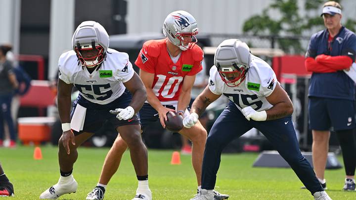 Jul 28, 2026; Foxborough, MA, USA; New England Patriots offensive lineman Jared Wilson (55) and guard Alijah Vera-Tucker (75) do a drill with quarterback Drake Maye (10) during training camp at Gillette Stadium. Mandatory Credit: Eric Canha-Imagn Images Jul 28, 2026; Foxborough, MA, USA; New England Patriots offensive lineman Jared Wilson (55) and guard Alijah Vera-Tucker (75) do a drill with quarterback Drake Maye (10) during training camp at Gillette Stadium. Mandatory Credit: Eric Canha-Imagn Images