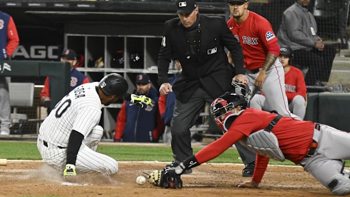 Apr 11, 2025; Chicago, Illinois, USA; Chicago White Sox third base Lenyn Sosa (50) slides safely into home plate as Boston Red Sox catcher Blake Sabol (18) misses the tag during the eighth inning at Guaranteed Rate Field. Mandatory Credit: Matt Marton-Imagn Images