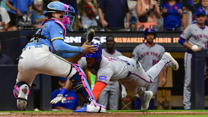 Aug 8, 2025; Milwaukee, Wisconsin, USA;  New York Mets designated hitter Starling Marte (6) tries to score but is tagged out by Milwaukee Brewers catcher William Contreras (24) in the ninth inning at American Family Field. Mandatory Credit: Benny Sieu-Imagn Images