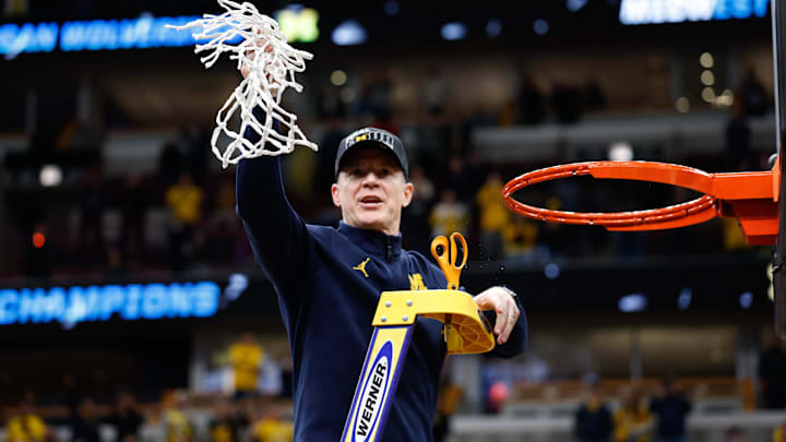 Mar 29, 2026; Chicago, IL, USA; Michigan Wolverines head coach Dusty May cuts the net after defeating Tennessee Volunteers in an Elite Eight game of the Midwest Regional of the men's 2026 NCAA Tournament at United Center. Mandatory Credit: Kamil Krzaczynski-Imagn Images