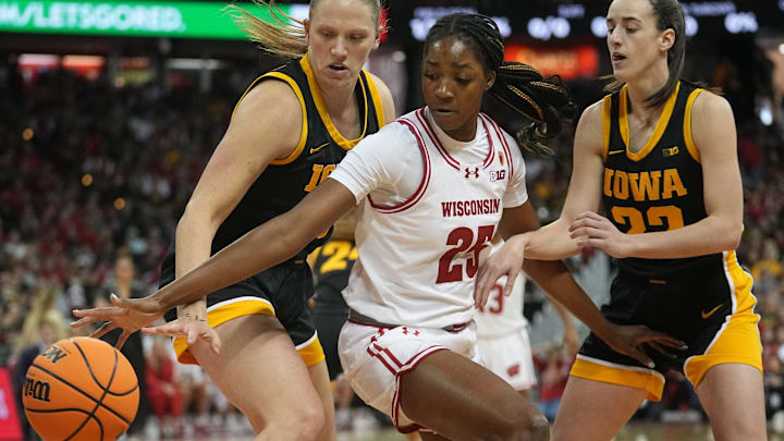 Wisconsin forward Serah Williams (25) is double-teamed Iowa center Sharon Goodman (40) and guard Caitlin Clark (22) during the first half of their game Sunday, December 10, 2023 at the Kohl Center in Madison, Wisconsin. Wisconsin forward Serah Williams (25) is double-teamed Iowa center Sharon Goodman (40) and guard Caitlin Clark (22) during the first half of their game Sunday, December 10, 2023 at the Kohl Center in Madison, Wisconsin.