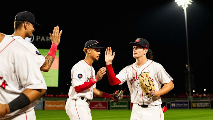 Roman Anthony high fives WooSox teammates following the Triple-A club's 12-2 win over Toledo on Tuesday at Polar Park.