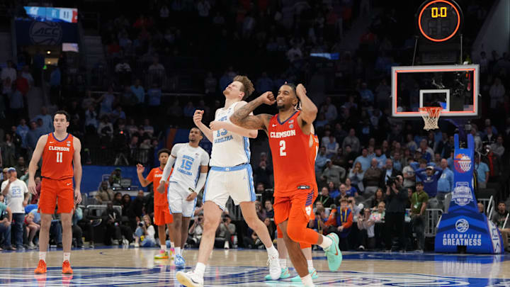 Mar 12, 2026; Charlotte, NC, USA; North Carolina Tar Heels center Henri Veesaar (13) rand Clemson Tigers guard Dillon Hunter (2) react at the end of the game at Spectrum Center. Mandatory Credit: Bob Donnan-Imagn Images