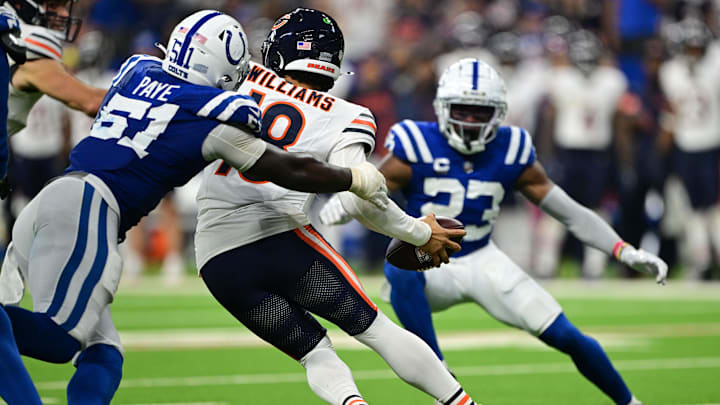 Sep 22, 2024; Indianapolis, Indiana, USA; Chicago Bears quarterback Caleb Williams (18) attempts to get away from Indianapolis Colts defensive end Kwity Paye (51) during the second half at Lucas Oil Stadium. Mandatory Credit: Marc Lebryk-Imagn Images

