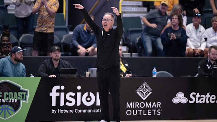 Dec 1, 2024; Estero, FL, USA; West Virginia University head coach Mark Kellogg calls a play in the from the sidelines in the fourth quarter during the Women's Gulf Coast Showcase at Hertz Arena. Mandatory Credit: Chris Tilley-Imagn Images