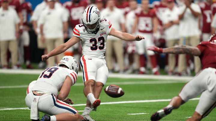 Dec 28, 2023; San Antonio, TX, USA; Aizona Wildcats place kicker Tyler Loop (33) kicks a 37-yard field goal out of the hold of punter Kyle Ostendorp (19) in the second half of the Alamo Bowl against the Oklahoma Sooners at Alamodome. Dec 28, 2023; San Antonio, TX, USA; Aizona Wildcats place kicker Tyler Loop (33) kicks a 37-yard field goal out of the hold of punter Kyle Ostendorp (19) in the second half of the Alamo Bowl against the Oklahoma Sooners at Alamodome.