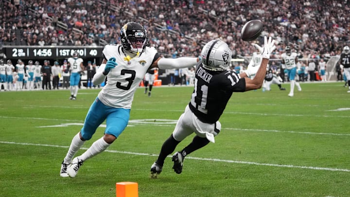 Dec 22, 2024; Paradise, Nevada, USA; Las Vegas Raiders wide receiver Tre Tucker (11) makes a catch against Jacksonville Jaguars cornerback Tyson Campbell (3) in the first half at Allegiant Stadium. Mandatory Credit: Kirby Lee-Imagn Images