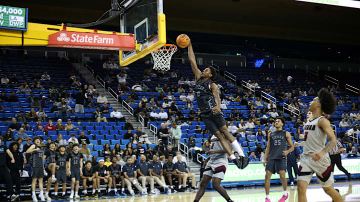 Brandon McCoy Jr. rises for a one-handed dunk against JSerra at Pauley Pavilion on November 22, 2025.