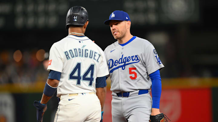 Sep 27, 2025; Seattle, Washington, USA; Seattle Mariners center fielder Julio Rodriguez (44) and Los Angeles Dodgers first baseman Freddie Freeman (5) talk during the fifth inning at T-Mobile Park. Mandatory Credit: Steven Bisig-Imagn Images