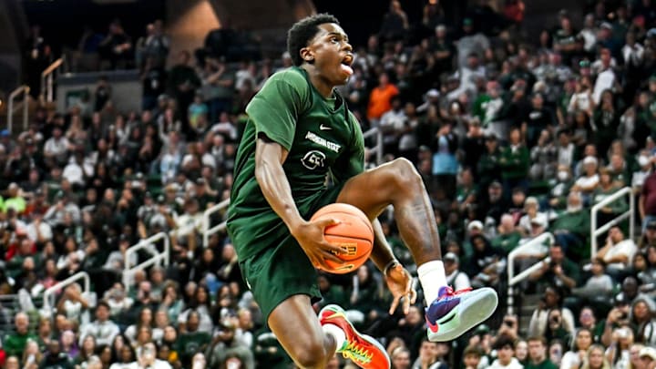 Michigan State's Coen Carr jumps over four men on a slam during the dunk contest during the Michigan State Madness event on Friday, Oct. 4, 2024, at the Breslin Center in East Lansing. Michigan State's Coen Carr jumps over four men on a slam during the dunk contest during the Michigan State Madness event on Friday, Oct. 4, 2024, at the Breslin Center in East Lansing.