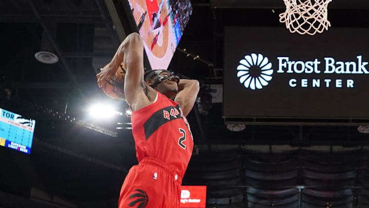 Apr 13, 2025; San Antonio, Texas, USA; Toronto Raptors forward Jonathan Mogbo (2) dunks ahead of San Antonio Spurs forward Harrison Barnes (40) during the first half at Frost Bank Center. Mandatory Credit: Scott Wachter-Imagn Images