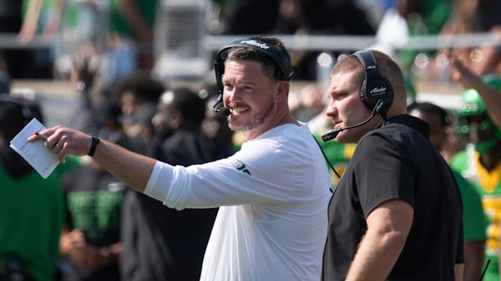 Oregon Head Coach Dan Lanning, left, and Defensive Coordinator Tosh Lupoi discus their game plan during the game against Oklahoma State.