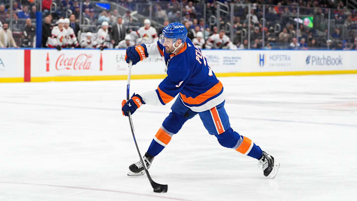 Apr 11, 2026; Elmont, New York, USA; New York Islanders defenseman Adam Pelech (3) shoots the puck in the second period at UBS Arena. Mandatory Credit: Alexander Wohl-Imagn Images