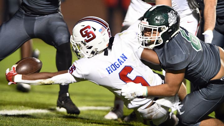 St. Ignatius senior tailback Jarious Hogan reaches out to get a first down in a 45-28 win over Sacred Heart Cathedral in the 101st meeting between the two teams. Hogan rushed for 265 yards and scored a West Catholic Athletic League record six touchdowns on Nov. 1, 2024. St. Ignatius is the top seed in the Open Division and hosts Salinas in a first-round game on Friday.