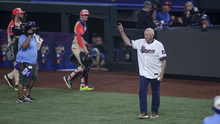 Former Houston Astros Nolan Ryan walking on the field and wavin