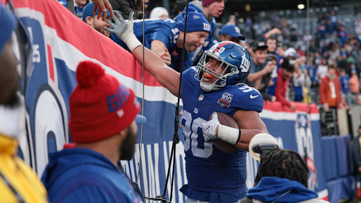 Dec 29, 2024; East Rutherford, New Jersey, USA; New York Giants defensive end Elijah Garcia (90) celebrates his fumble recovery with fans during the second half against the Indianapolis Colts at MetLife Stadium. Dec 29, 2024; East Rutherford, New Jersey, USA; New York Giants defensive end Elijah Garcia (90) celebrates his fumble recovery with fans during the second half against the Indianapolis Colts at MetLife Stadium.