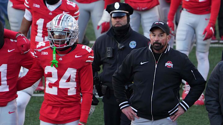 Ohio State coach Ryan Day watches the melee on the field after the loss to Michigan.