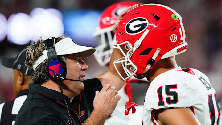 Sep 28, 2024; Tuscaloosa, Alabama, USA;  Georgia Bulldogs head coach Kirby Smart talks with quarterback Carson Beck (15) during the first half against the Alabama Crimson Tide at Bryant-Denny Stadium. Mandatory Credit: John David Mercer-Imagn Images