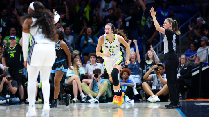 May 15, 2024; Arlington, Texas, USA; Dallas Wings forward Maddy Siegrist (20) reacts after scoring over Chicago Sky guard Dana Evans (11)  during the second half at College Park Center. Mandatory Credit: Kevin Jairaj-USA TODAY Sports