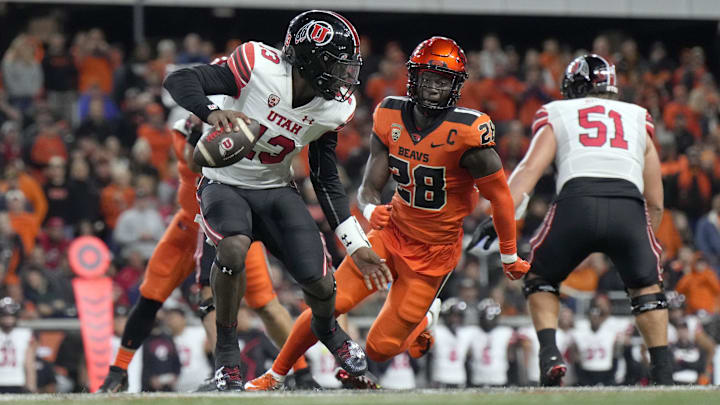 Sep 29, 2023; Corvallis, Oregon, USA; Utah Utes quarterback Nate Johnson (13) scrambles under Sep 29, 2023; Corvallis, Oregon, USA; Utah Utes quarterback Nate Johnson (13) scrambles under